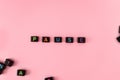 Pause button concept. Black beads on pink background making word Royalty Free Stock Photo