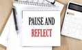PAUSE AND REFLECT text on paper on chart background Royalty Free Stock Photo