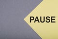 Pause Text written on yellow page, with gray nackground. Motivational Concept image