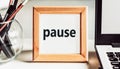 Pause. Work, study, break and rest concept. Text on a frame with an office tolls