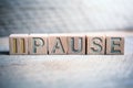 Pause Written On Wooden Blocks On A Board