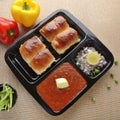 Pav bhaji is a fast food dish from India, consists of a thick vegetable curry served with a soft bread roll, served in a plate