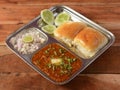 Pav Bhaji is a fast food dish from India, Thick and spicy vegetable curry, served with a soft bread roll or Bun Paav and butter. Royalty Free Stock Photo