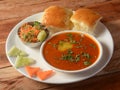 Pav Bhaji is a fast food dish from India, Thick and spicy vegetable curry, served with a soft bread roll or Bun Paav and butter. Royalty Free Stock Photo