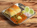 Pav Bhaji is a fast food dish from India, Thick and spicy vegetable curry, served with a soft bread roll or Bun Paav and butter. Royalty Free Stock Photo