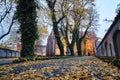 Paved alleyway and medieval church during autumn