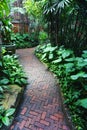 Brick walkway through a lush tropical garden Royalty Free Stock Photo