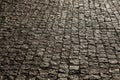 Paved city with porphyry cubes. Texture of cobblestone. Floor of a street with stone tiles.