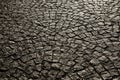 Paved city with porphyry cubes. Texture of cobblestone. Floor of a street with stone tiles.