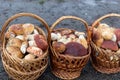 Paved country road in the mountains and three baskets of large porcini mushrooms for sale. Royalty Free Stock Photo