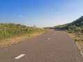 Paved cycle track with dividing line in the Amsterdam water supply dunes near to Amsterdam and Zandvoort Royalty Free Stock Photo