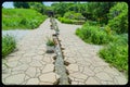 Paved path with running water duct Holy family shrine Gretna Nebraska Royalty Free Stock Photo