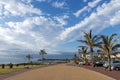 Paved Promenade Against Coastal Landscape and Blue Cloudy Sky Royalty Free Stock Photo
