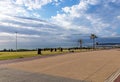 Paved Promenade and Sea Against Blue Cloudy Sky Landscape Royalty Free Stock Photo