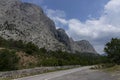 A paved road along rocky mountains with a dangerous curve. Landscape