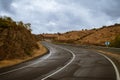 Paved road with curves and wet from the recent autumn rain. Royalty Free Stock Photo