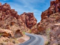 Paved road through a jagged rocky canyon.