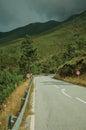 Paved road passing through hilly landscape