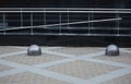 Paved sidewalk with concrete hemispheres and metal railings