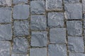 Paved with square granite pavement of dark gray color. The pavement laid with square stone cobbles of granite. Royalty Free Stock Photo