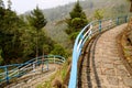 Paved stone curved footpath in rock garden Royalty Free Stock Photo