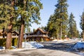 Paved street in south Lake Tahoe on a sunny winter day, snow covering the sidewalks