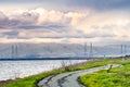 Paved trail following the green grass covered shoreline of south San Francisco bay area, Mountain View, California Royalty Free Stock Photo