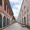 Paved walkway surrounded by aged stone brick walls in the courtyard of Topkapi palace, Istanbul, Turkey