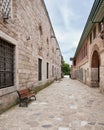 Paved walkway surrounded by aged stone brick walls in the courtyard of Topkapi palace, Istanbul, Turkey