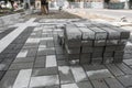 Pavement cobblestone in the stack on the street. Concrete or granite gray square pavement slabs for sidewalk Royalty Free Stock Photo