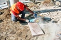 Pavement construction worker using an angle grinder for cutting the tiles Royalty Free Stock Photo