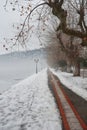 Pavement covered with snow on the banks of frozen lake Orestiada in Kastoria