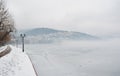 Pavement covered with snow on the banks of frozen lake Orestiada in Kastoria