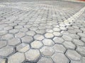 Pavement hexagonal stone background with lines. Hexagonal paving cobble texture laid on city street