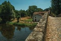 Pavement over an old Roman bridge and house in Portagem Royalty Free Stock Photo