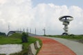 Pavement, pedestrian bridge and modern deserted building on background