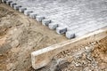 Pavement repair and laying of paving slabs on the walkway, stacked tile cubes on the background. Laying paving slabs in the