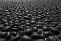 Pavement with round black boulders