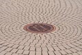Manhole in street with circular pattern Royalty Free Stock Photo