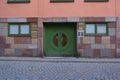 Pavement and a square green door of a building in historic district in Stockholm, Sweden Royalty Free Stock Photo