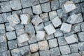 Pavement, stone blocks and construction tools. Construction worker laying cobblestone pavement stones