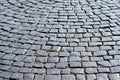 Pavement stone blocks of dark stone of the old part of the city. Textured background Royalty Free Stock Photo