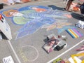 pavement street artist painting over the asphalt in Madonnari competition of chalk paintings