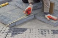 Paver measuring irregular space for laying concrete brick 2 Royalty Free Stock Photo