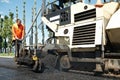 Paver worker at asphalting works