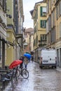 PAVIA, ITALY - MAY 14, 2018: This is one of the streets of the old city under the warm spring rain
