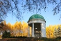 Pavilion in a park with yellow birch trees