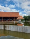 a pavilion with a pool filled with water around it with a bright blue sky as a background Royalty Free Stock Photo