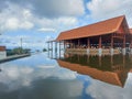 a pavilion with a pool filled with water around it with a bright blue sky as a background