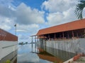 a pavilion with a pool filled with water around it with a bright blue sky as a background Royalty Free Stock Photo